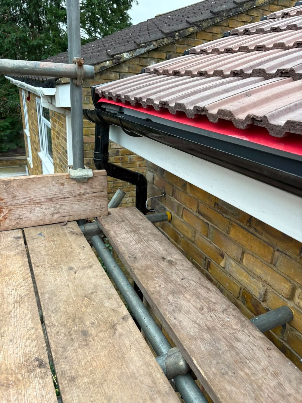 Black gutter and downpipe installation