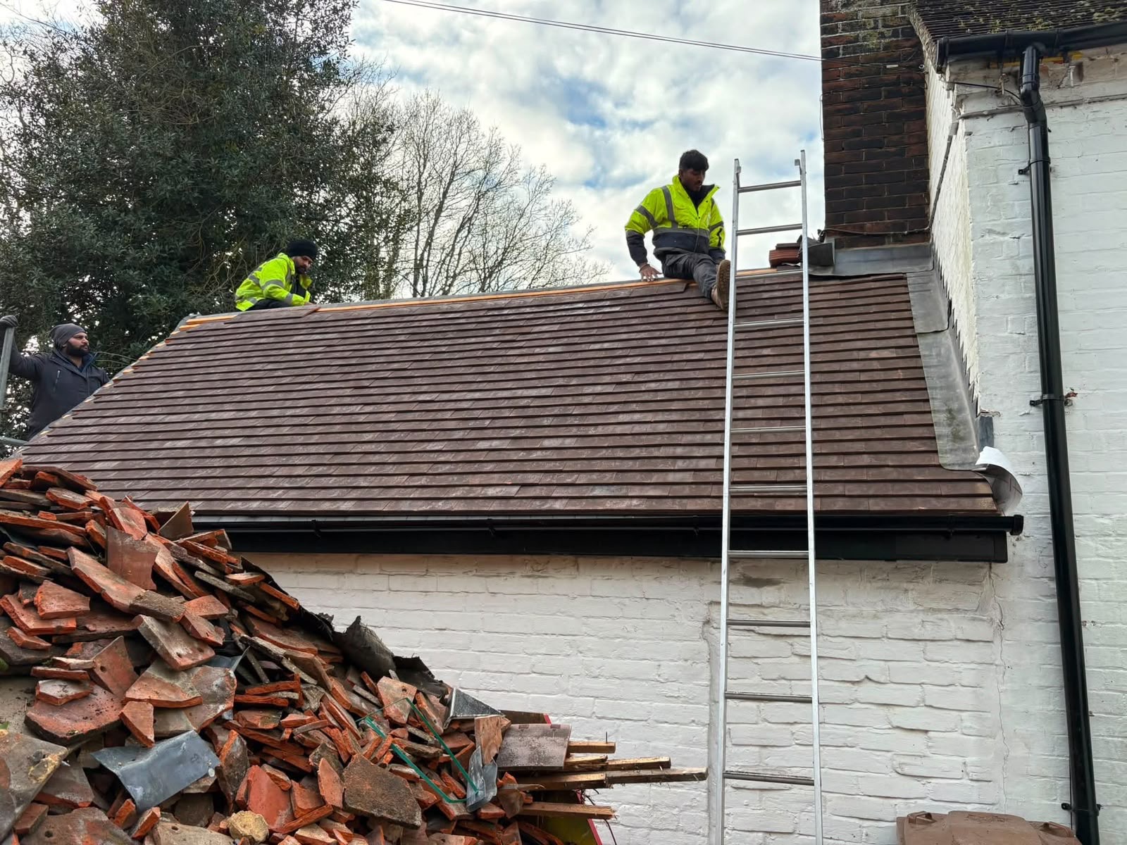 Roof 2 Ridges team installing roof tiles on site in Northampton