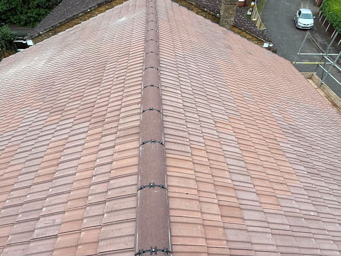 Terracotta tile ridge installation from scaffold