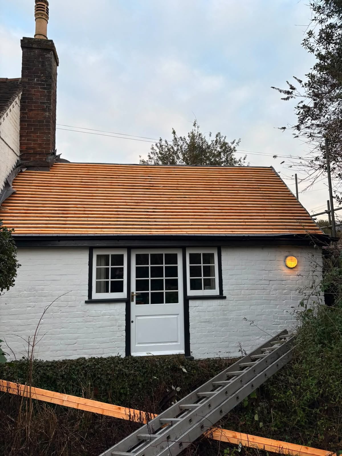 White cottage with new roof battens fitted